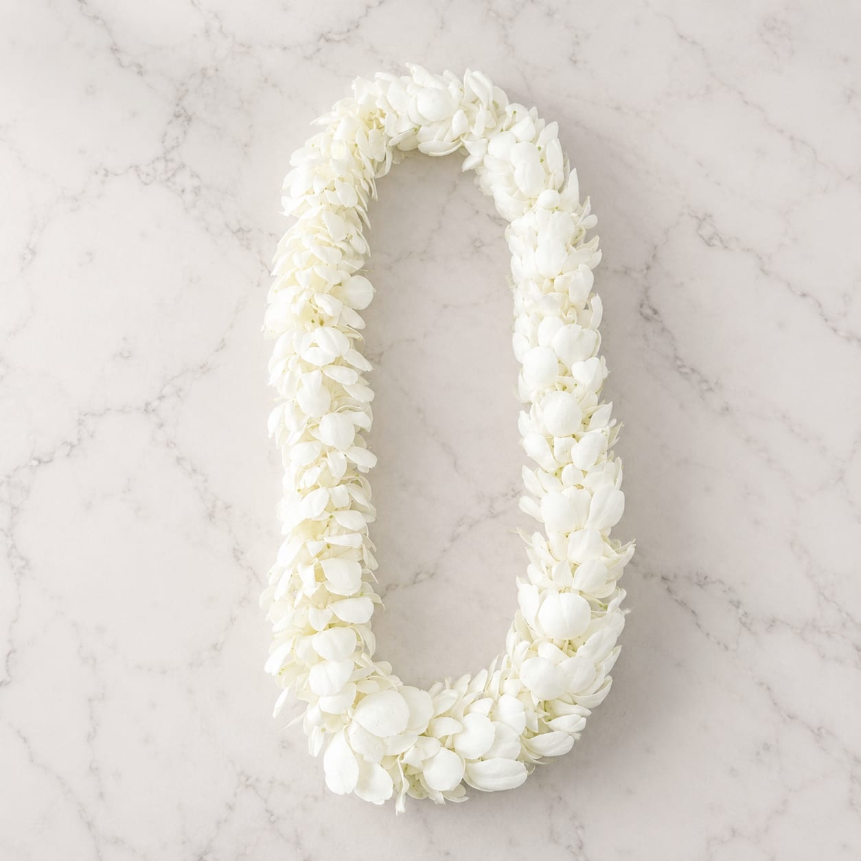 White Orchid Lei – Elegant Tropical Floral Lei (Same-Day Delivery Los Angeles) - Celebrate life’s most meaningful moments with our handcrafted White Orchid Lei, designed using fresh premium white dendrobium orchids for a clean, elegant, and luxurious look. Each lei is carefully created to showcase lush texture, soft movement, and timeless tropical beauty.  Known for symbolizing love, honor, celebration, and new beginnings, white orchid leis are a thoughtful gift for graduations, performances, weddings, anniversaries, birthdays, and welcoming ceremonies. Its versatile and sophisticated style makes it perfect for both men and women.  Every lei is handcrafted fresh to order by our floral designers and available for same-day flower delivery throughout Los Angeles and surrounding areas including Glendale, Pasadena, Burbank, Eagle Rock, Highland Park, and more.  Flowers Included Fresh White Dendrobium Orchids Perfect For Graduation Celebrations Weddings &amp; Ceremonies  Hawaiian &amp; Tropical Events Dance Performances Anniversaries Welcome Gifts Special Celebrations Design Details Handcrafted fresh floral lei Elegant all-white floral palette Lightweight and comfortable to wear Tropical-inspired luxury style Fresh premium orchid blooms Designed by hand in Los Angeles Note  Due to the seasonal nature of flowers, slight variations may occur while maintaining the overall style, color palette, and design integrity of the lei.  Categories: Graduation Flowers, Tropical Flowers, Wedding Flowers, Celebration Flowers, Sympathy &amp; Memorial Flowers, S y Los Angeles