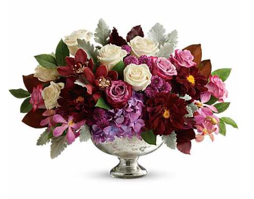 Beautiful Harvest Centerpiece -  Pet Friendly? No - This arrangement contains Chrysanthemums, which are toxic to both dogs and cats if ingested.  Keep this centerpiece on a high table or mantel out of reach of curious household pets.   Human Allergy Note : Pollen Warning. This arrangement includes Chrysanthemums and Dahlias, which are known to produce pollen that can trigger sensitivities.  Keep the arrangement in a well-ventilated area and avoid placing it directly on bedside tables for those with hay fever.   Care &amp; Longevity : To keep these blooms vibrant, check the water level daily by peering through the stems; add fresh, cool water to the bowl to keep it full. Since this is a dense arrangement, ensure no leaves are submerged in the water to prevent bacteria.  Keep the bowl away from direct sunlight, heating vents, and ripening fruit to extend the life of the orchids and dahlias.   Best Occasions &amp; Situations :  - Autumn flower gatherings  - Romance/anniversary dinners  - Wedding's reception table  - Thanksgiving centerpiece  - Housewarming gift  - Just because gesture  - Congrats/celebration dinner  - Fourth of july table decor  Why Customers Love It : - Rich Color Palette: The blend of jewel tones and cream creates a high-contrast, expensive look. - Low Profile: The height is perfect for conversation across a dining table. - Textural Variety: The mix of velvet Dusty Miller, waxy Orchids, and ruffled Dahlias is visually captivating.