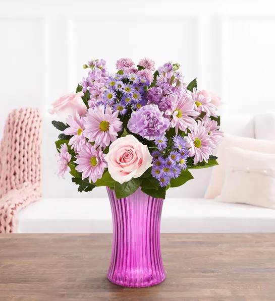 Pink and lavender mixed bouquet in a tall purple vase