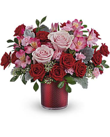 Bouquet of red and pink roses in a red vase