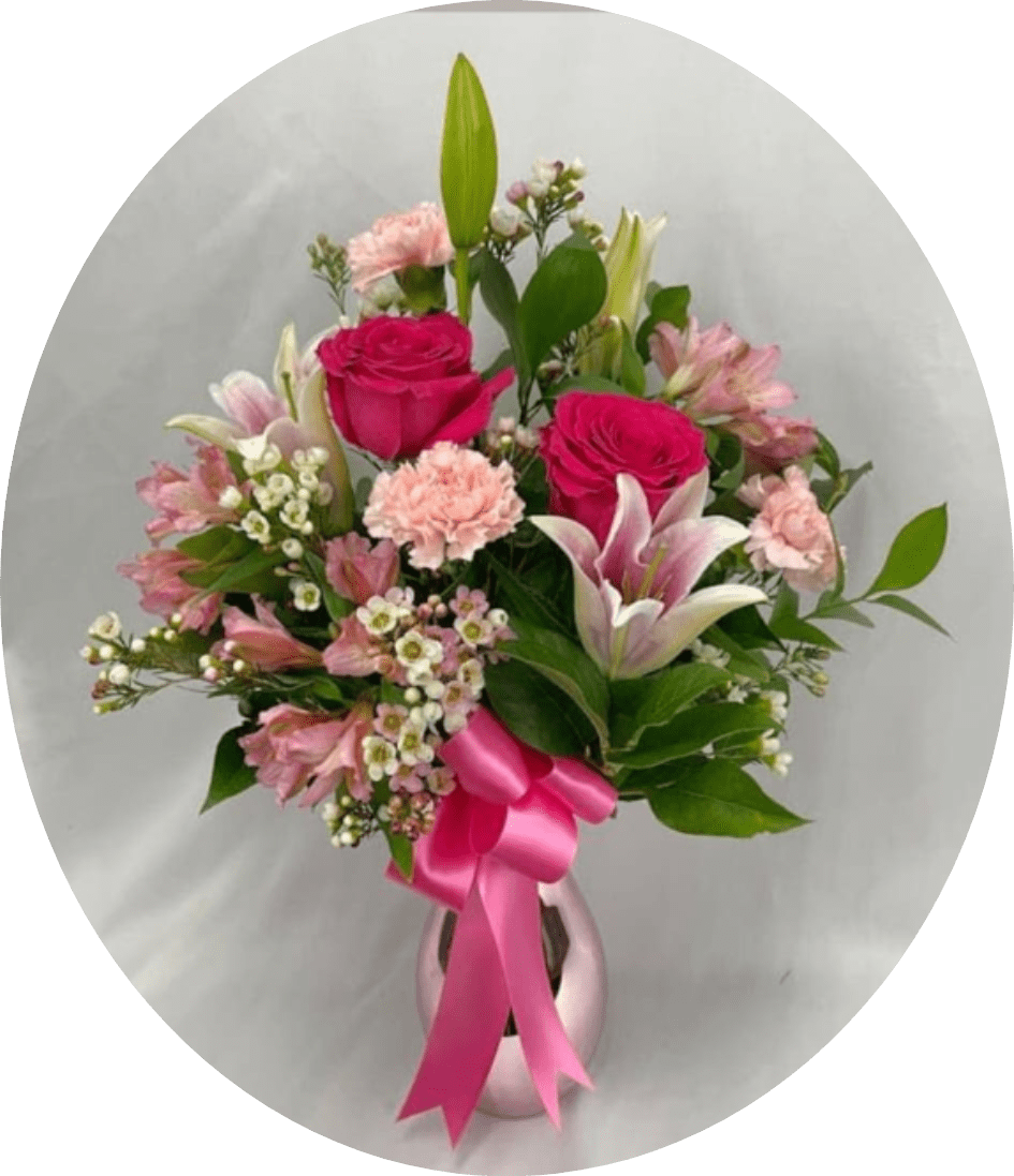 SAMANTHA - Soft pink and white roses paired with pale tulips and ruffled carnations create a gently romantic birthday bouquet that feels freshly gathered and feminine. The rounded hand-tied shape mixes open blooms and tight buds for textured depth, and the gray paper wrap with a pink satin ribbon gives a clean, modern finish-perfect for anniversaries, Valentine's Day, or to make someone feel truly cherished.  For a more indulgent gift, choose the white presentation box set with three compartments: a floral section of deep red roses with delicate white fillers, a heart-shaped center of assorted gold-wrapped chocolates around a pink candy box, and a U-shaped selection of Ferrero Rocher-an elegant combo for romantic celebrations or a special thank-you. Alternatively, the clear glass vase options offer versatile styles-from clustered white hydrangeas with pale pink roses and airy greenery for an elegant, wedding-ready look, to bright and cheerful groupings of pink roses, alstroemeria, carnations, and lilies in a shiny pink metallic vase for a polished Mother's Day or birthday surprise. Each arrangement is designed to present beautifully on arrival and make the recipient feel seen and celebrated; select vase or boxed presentation at checkout.
