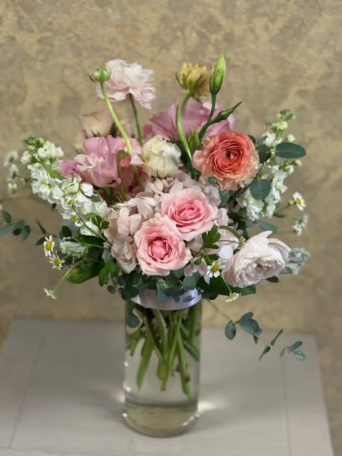 Mother Day Special 2026 - Recipe: Seasonal Ranunculus, Spray Roses, Stock, Hydrangae, Lisnathus, Camomille, and Eucalyptus in a clear 7.5" h x 3.5" w vase. Perfect for any spring event or special occasion.  