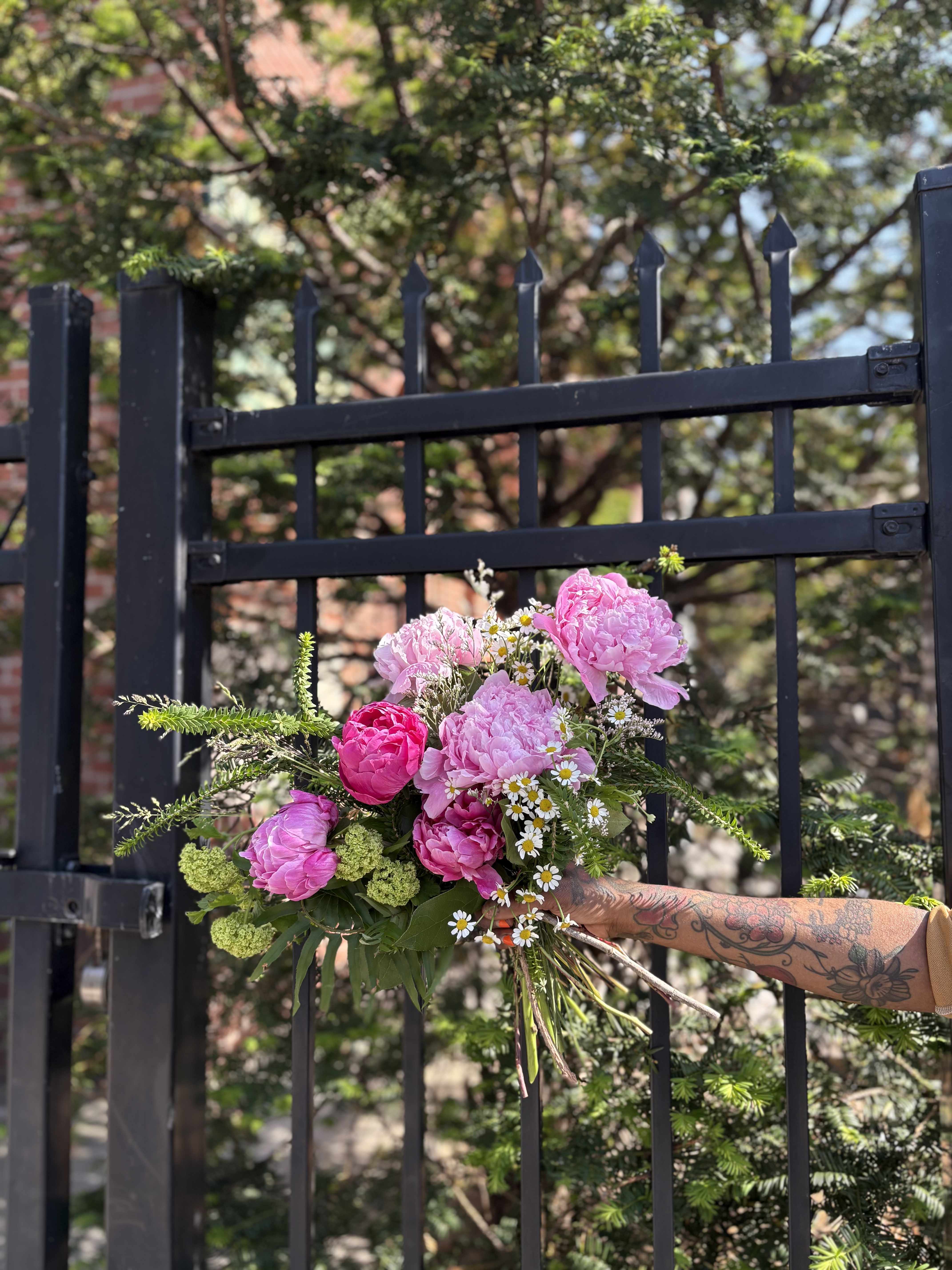 Plenty of Peonies Bouquet  - Give your special lady the flower of the season, Peonies!   Our Peony bouquet is created using the most beautiful local light and dark pink peonies, seasonal grasses, local viburnum, and spring filler. Want more peonies?  Upgrade it to a deluxe or premium for an even more bountiful bouquet! 
