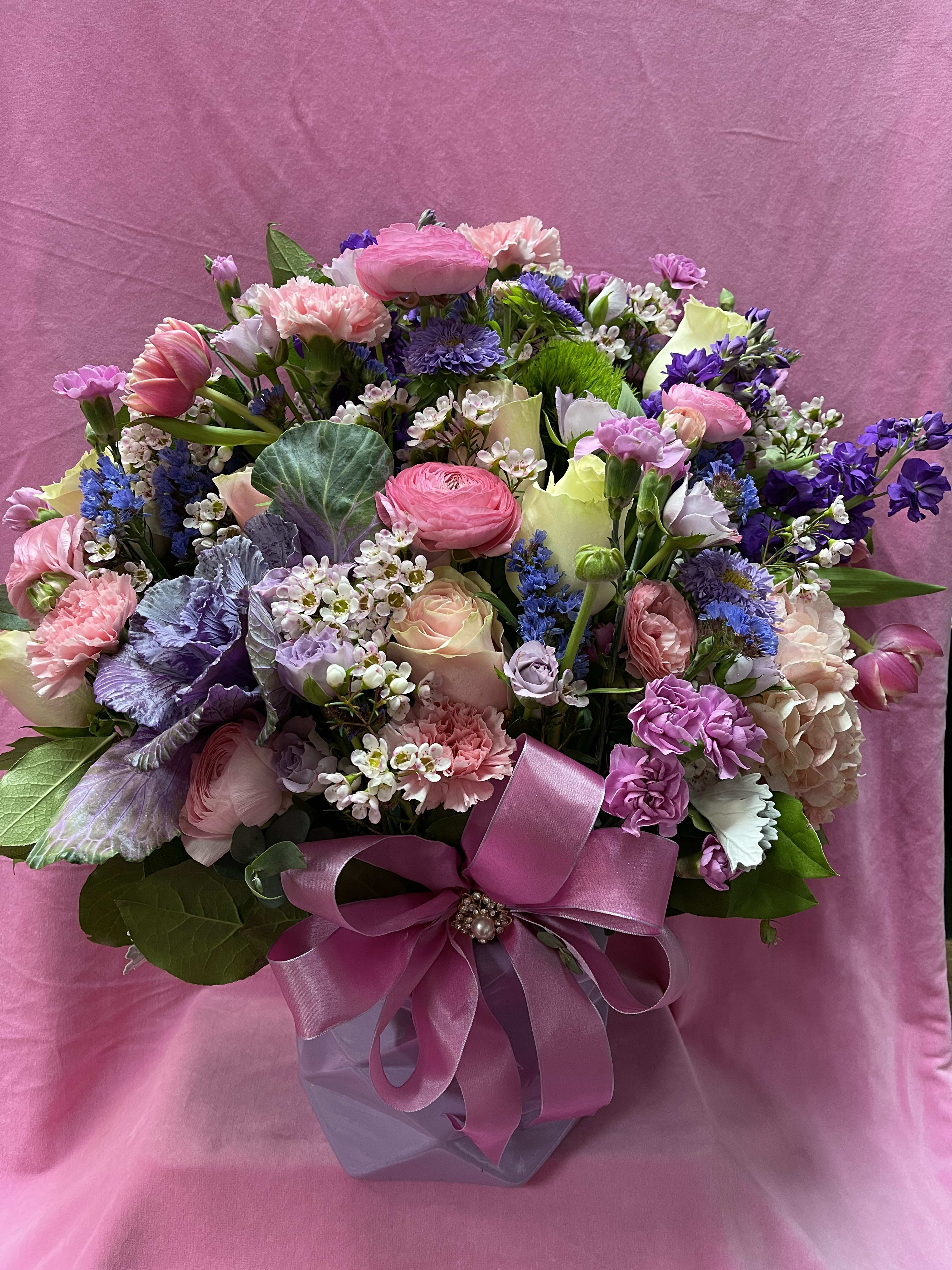 Mixed pink and purple bouquet in a gift box with a satin ribbon