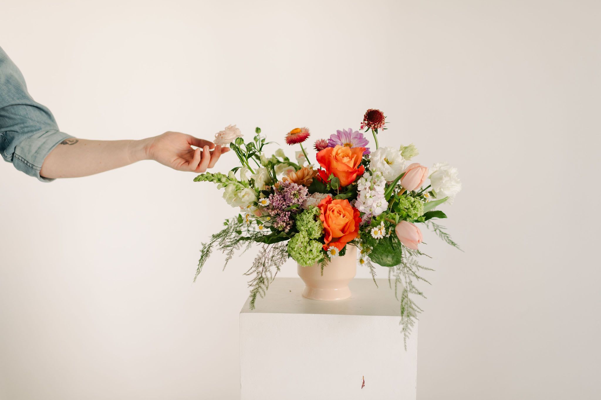 Spring Centerpiece - A lush blend of peaches, blush pinks, soft lavenders, and fresh greens, this statement centerpiece is the perfect addition to a spring brunch or just to bring some extra sunshine into your home!  Filled with beautiful blooms such as romantic roses, dramatic dahlias, fluffy lisianthus, lush tulips and fragrant lilac  Occasionally, we may need to substitute individual blooms due to daily and seasonal availability so arrangements may not look exactly as pictures, but we will always substitute with similar flowers where possible.