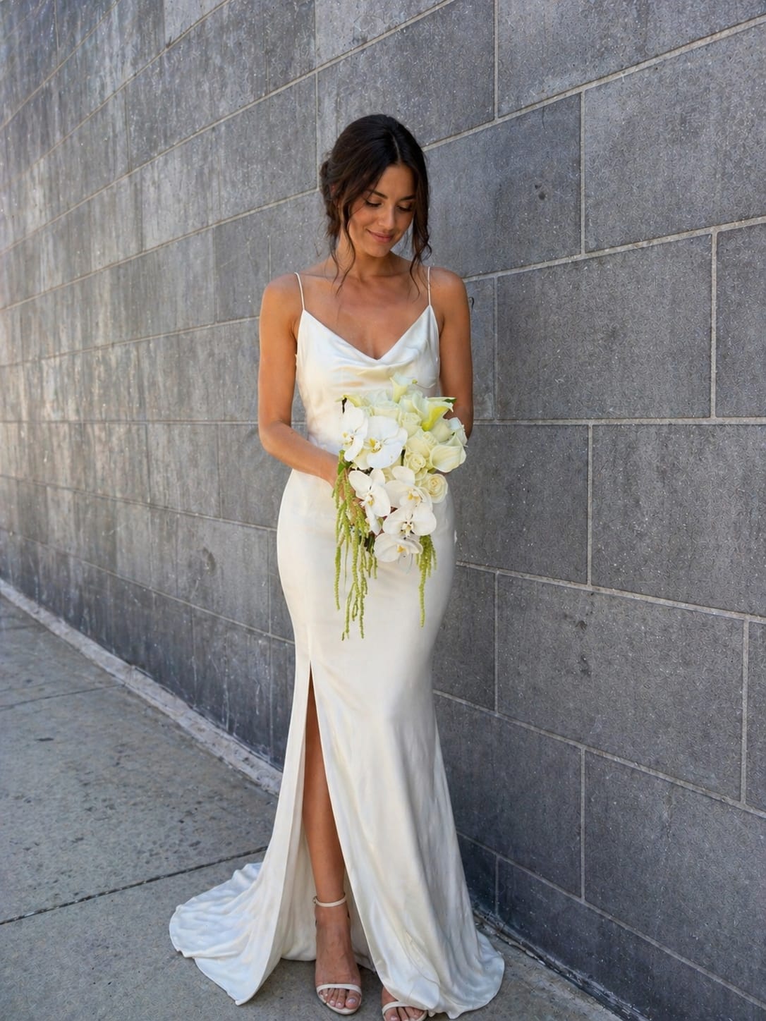 Cascading Orchid &amp; Calla Lily Bridal Bouquet – Luxury Wedding Flowers Los Angeles - This stunning cascading bridal bouquet is designed for a modern bride who wants to make a statement. Featuring elegant white orchids, calla lilies, and premium roses, this bouquet flows beautifully with soft greenery, creating a sophisticated and unforgettable look.  The cascading shape adds movement and luxury, making it a perfect choice for wedding ceremonies, photoshoots, and special occasions in Los Angeles. Each bouquet is thoughtfully designed to complement the bride’s dress while maintaining a clean, high-end aesthetic.  Ideal for brides seeking luxury wedding flowers in Los Angeles, this bouquet pairs perfectly with a matching calla lily boutonniere for the groom, creating a cohesive and elegant wedding style.  Available for wedding flower delivery in Los Angeles, Hollywood, and West Hollywood. Pre-order recommended for custom design and premium flower selection.