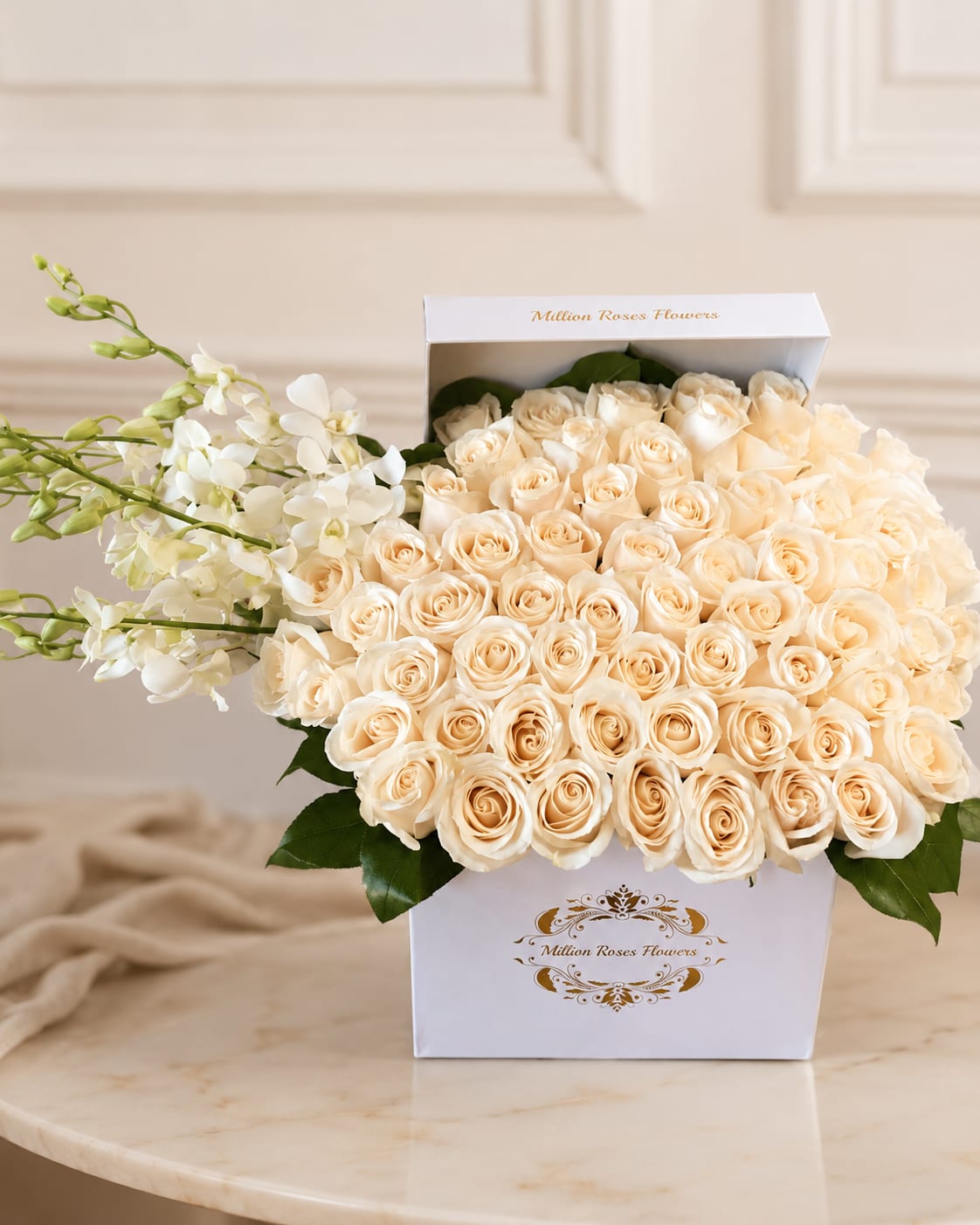 Cream roses in a white gift box with white orchids