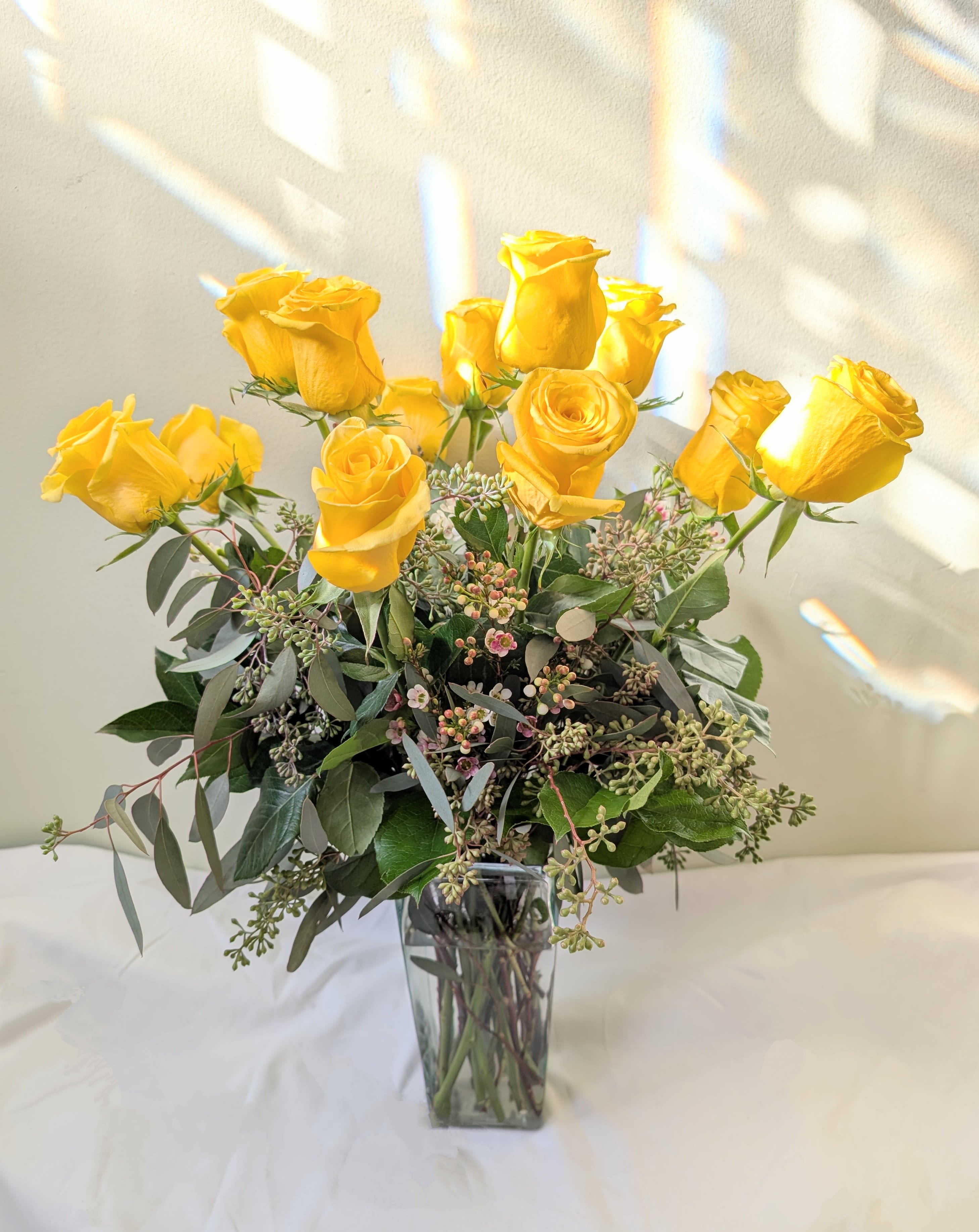 Felicitations_ Dozen Yellow Rose - Yellow roses are a great option to send a non-romantic love. Send a dozen yellow roses to your friend or family member to brighten up their space and celebrate them! Yellow roses are a good gift for graduations, birthdays, or celebrating an accomplishment like a new job.  Approximate Dimensions: 18"D x 25"H