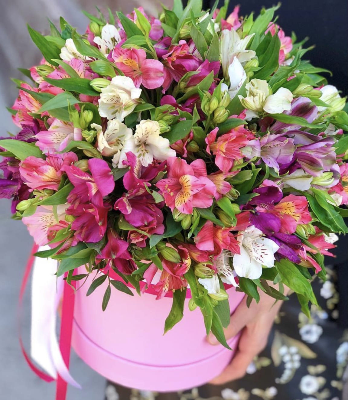 Pink and white alstroemeria bouquet in a round pink box