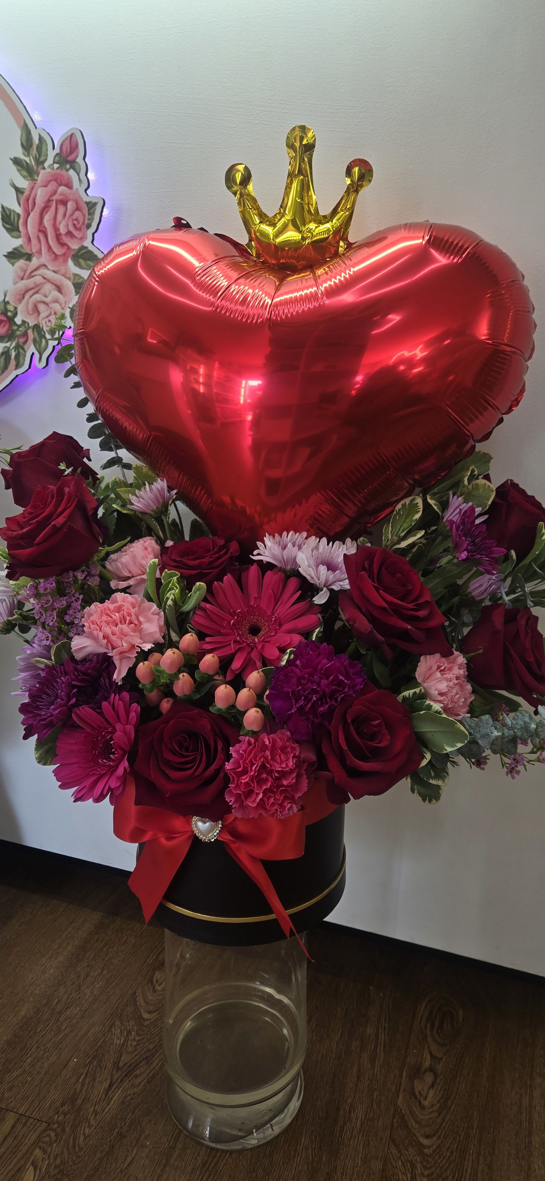 The Queen of Hearts - gold crown, heart-shaped balloon, and rich mix of red roses and pink carnations,
