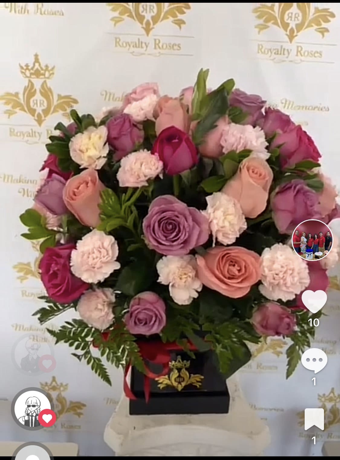 Mothers Day preferred colors - A lush cluster of pink, lavender, peach, and white blooms makes a soft, romantic statement she'll adore - perfect as a Mother's Day arrangement or a birthday bouquet that feels both feminine and luxurious. The rounded composition of roses and pale carnations is designed to read as an intentional, gift-ready surprise for the person you're thinking of, the kind of floral gift that makes her feel truly seen and celebrated.  Roses in pink, lavender and peach are packed tightly with small pale carnations to create a dense, textured dome of petals. The flowers sit low in a sleek black square box, finished with a red ribbon for a polished contrast that keeps the look modern and refined. This compact presentation is easy to display on a breakfast table, vanity, or office desk and carries a delicate scent without overwhelming a room.  Ideal for Mother's Day, anniversaries, or a thoughtful everyday gesture, this arrangement sends a message of warmth and appreciation. Choose this when you want her to feel cherished - the low-profile box keeps flowers neatly arranged and simple care (fresh water at delivery and trimming any stems that sit above the foam) will help the bouquet last through the special week ahead.