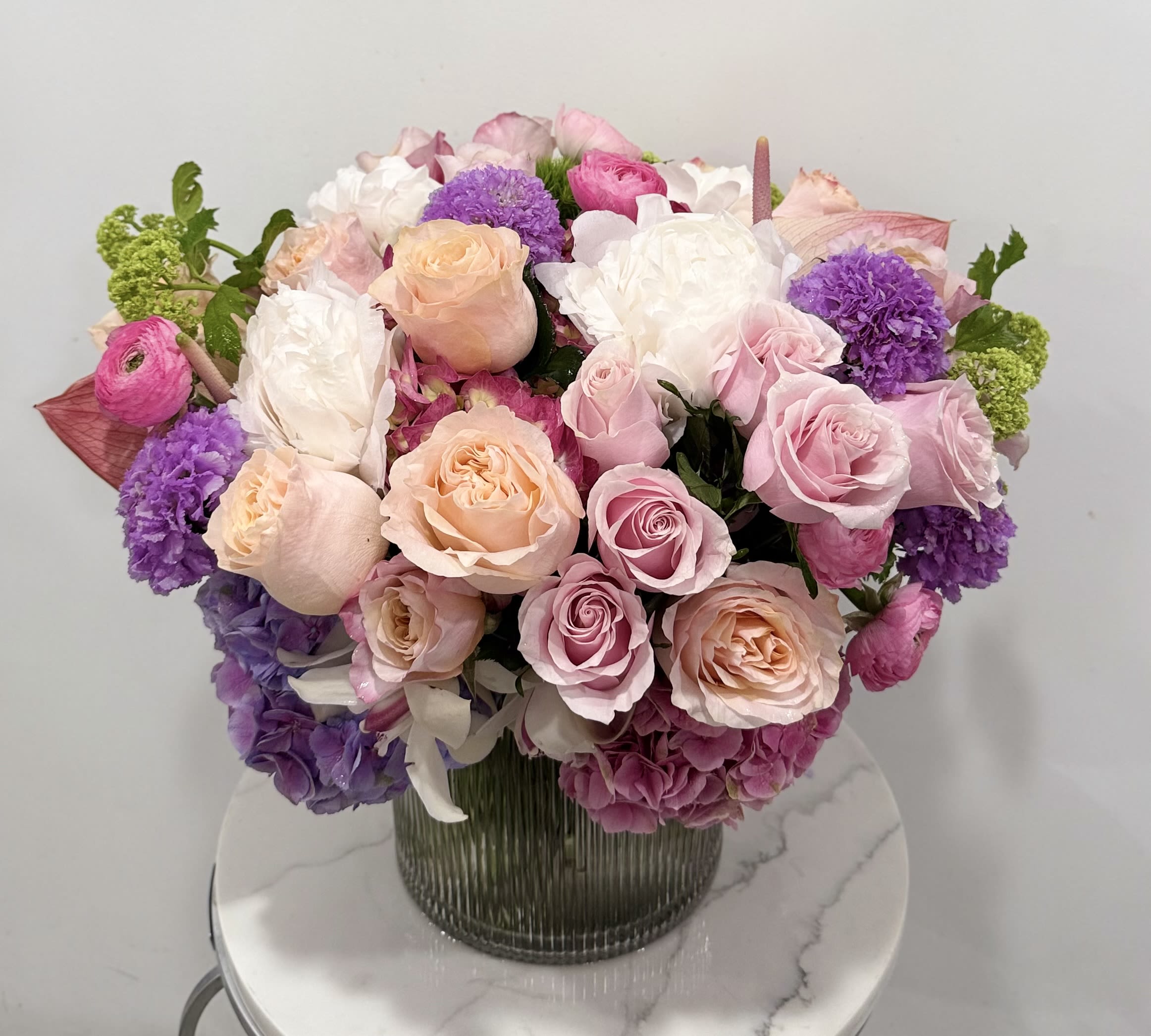 Blush Garden - A soft and romantic mix of blush roses, peonies, hydrangeas, and seasonal blooms arranged in a modern glass vase. Elegant, full, and perfect for Mother’s Day.