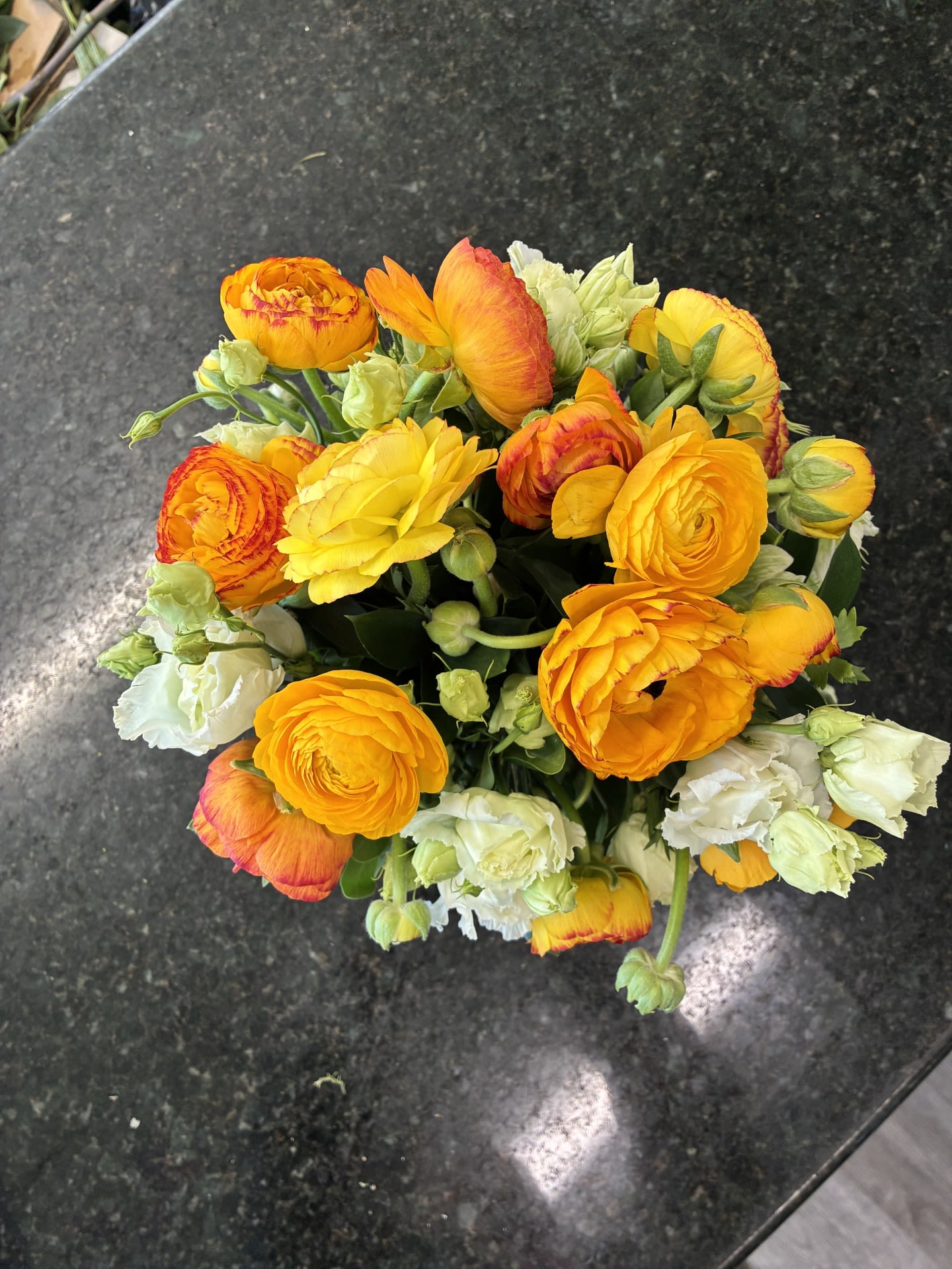 Mums Love Ranunculus in Yellow - Ranunculus arranged in a lined Cube with a touch or White Lisianthus to compliment ( and Helleborus ) standing about 11 inches tall and 10 inches Wide.