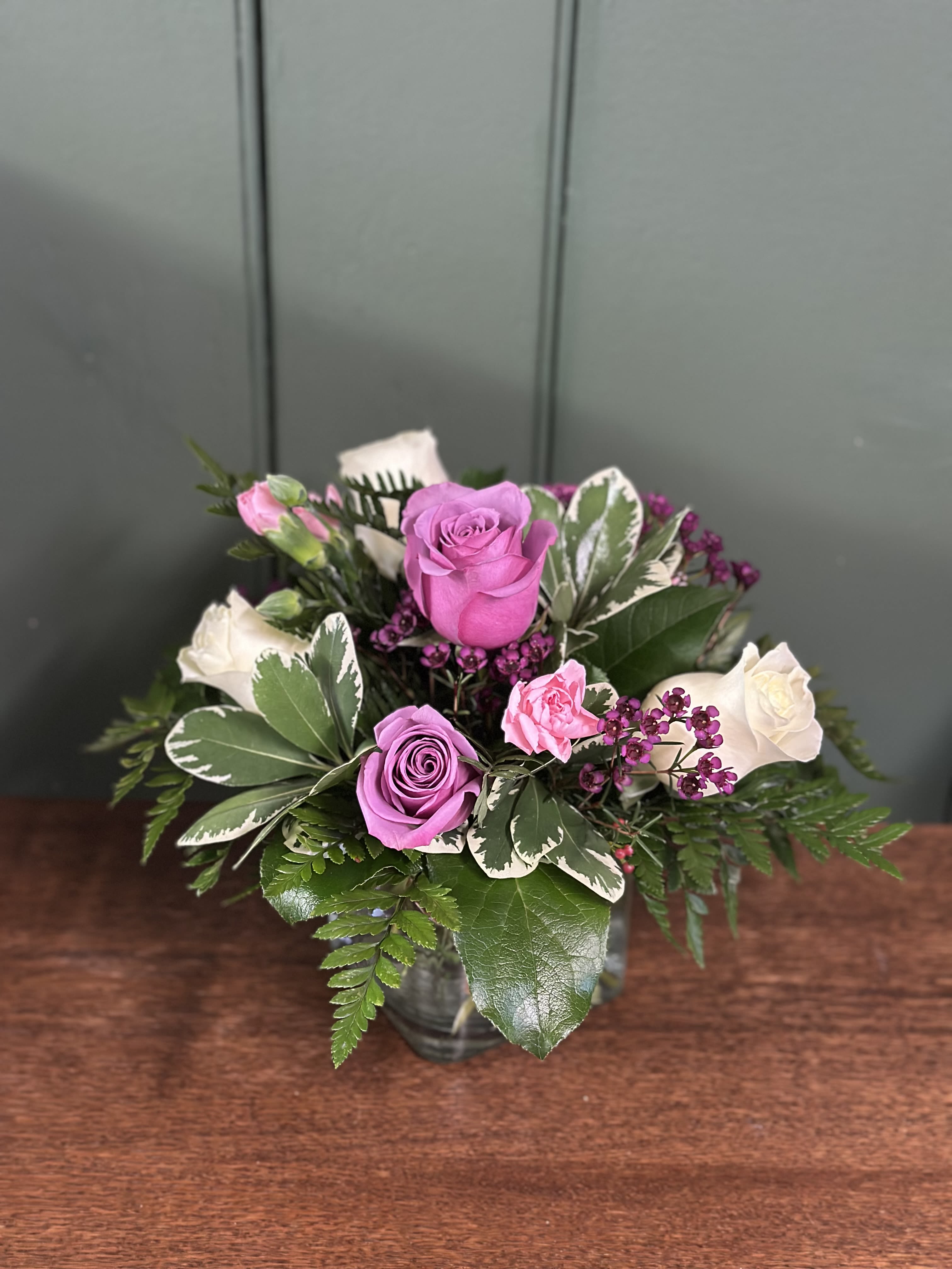 Lavender Kisses - A graceful blend of lavender and white roses accented with soft pink and lush greenery thoughtfully designed to brighten her day.