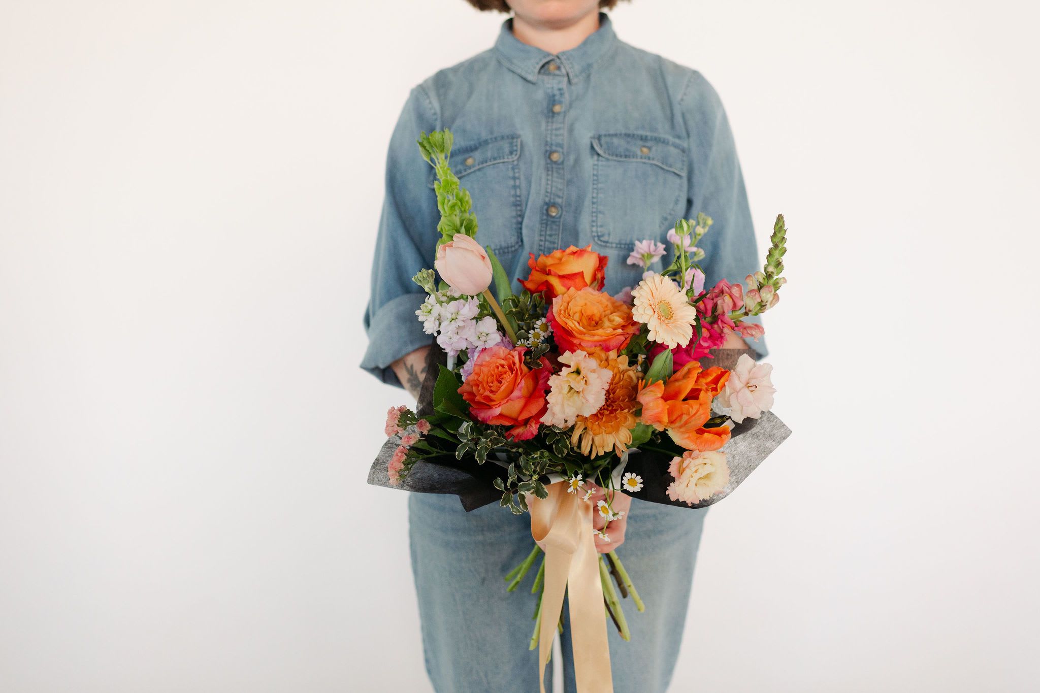 Spring Special Luxe Hand-Tied Bouquet - Medium - A stunning, premium hand-tied arrangement including Free Spirit roses, fluffy lisianthus, lush parrot tulips and sculptural bells of Ireland enhanced with dramatic snapdragons, fragrant stock and fresh greenery.