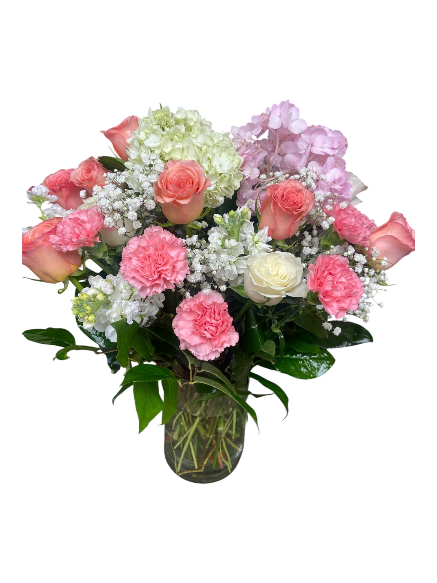 Pink roses and carnations in a glass vase with white and lavender blooms