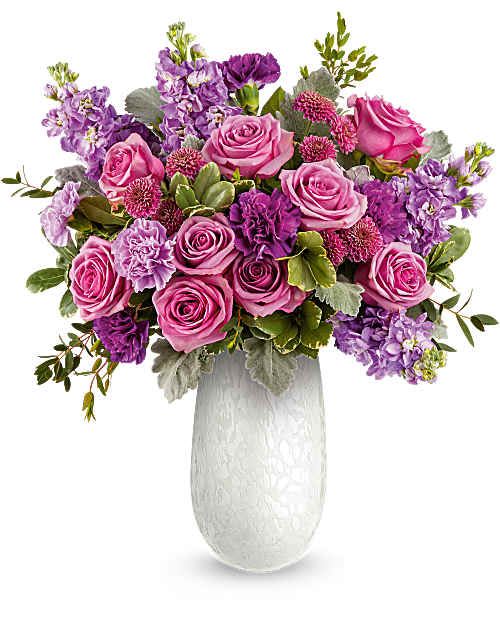 The Amelia Bouquet  - The Amelia Bouquet is an elegant Mother's Day floral arrangement featuring lavender roses, lavender and purple carnations, lavender stock, and purple button spray chrysanthemums, accented with dusty miller, parvifolia eucalyptus, and variegated pittosporum.