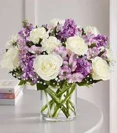 Lovely Lavender Medley  - Lovely memories are made with thoughtful gifts for the ones we care about. Our charming lavender flower bouquet is loosely gathered with a medley of lavender &amp; white blooms. Hand-designed inside a clear cylinder vase with cascading greenery all around.