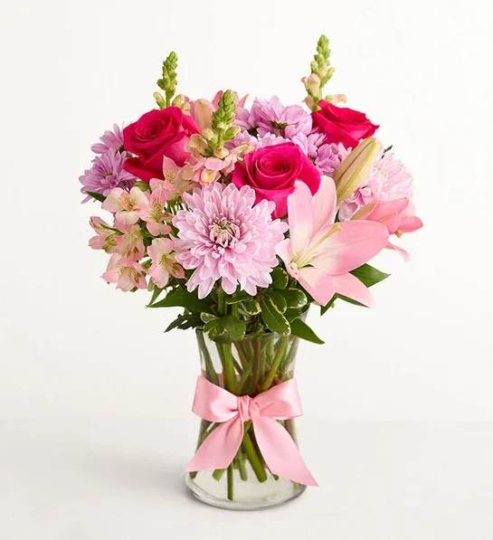 Mother's Embrace  - Thank Mom for a lifetime of comforting hugs with our Mother’s Embrace bouquet. Lovely pink and lavender blooms are hand-designed in a glass vase tied with a pink satin ribbon.