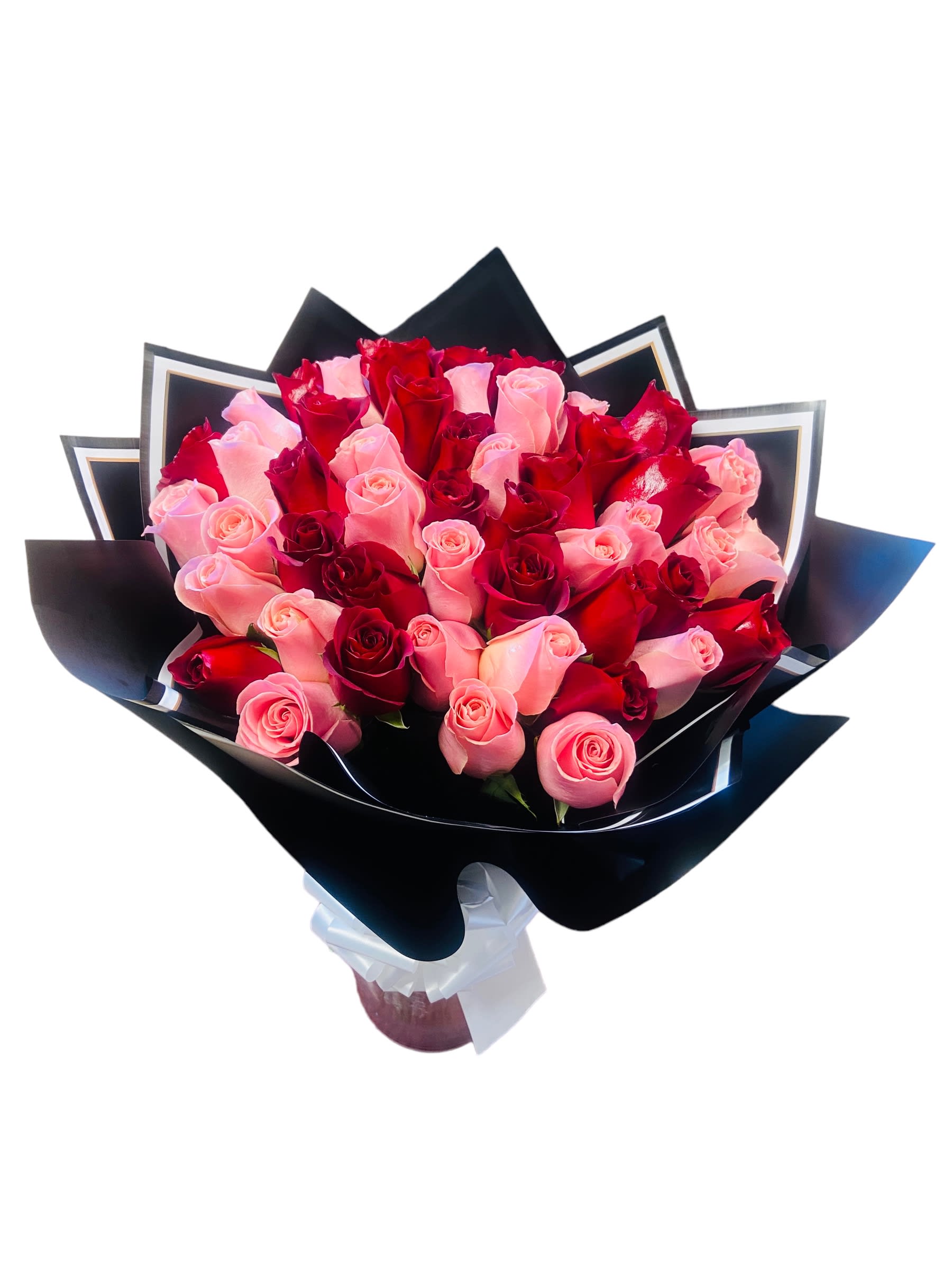 Bouquet of pink and red roses wrapped in black paper