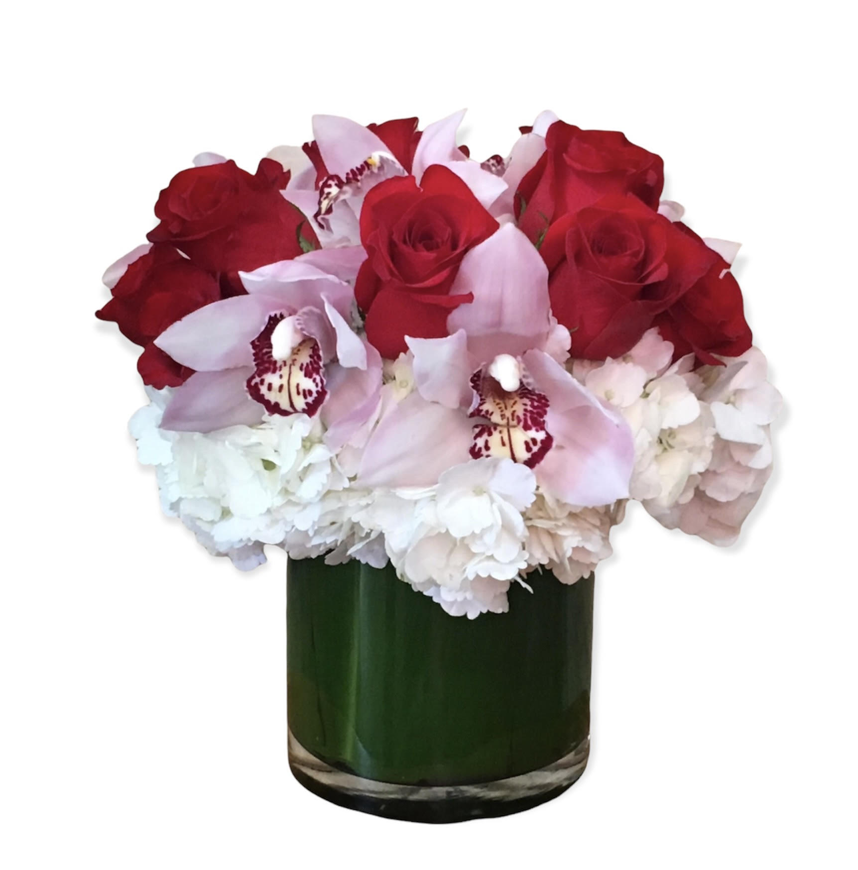 Red roses and pale pink orchids in a green glass vase