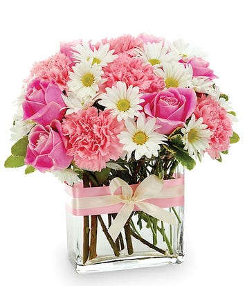 Pink roses and carnations with white daisies in a glass vase