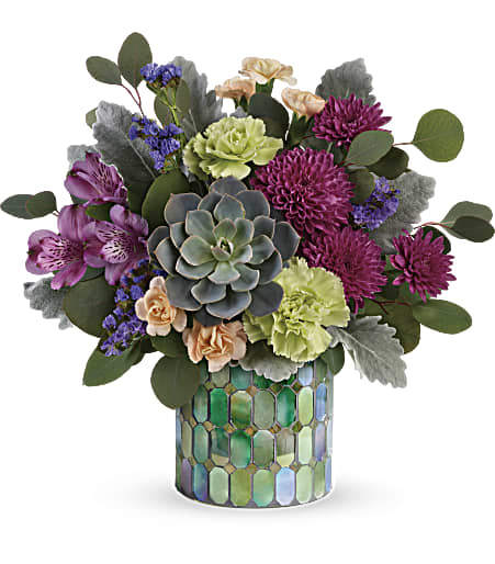 Succulent and mixed flower arrangement in a mosaic glass vase