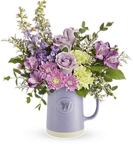 Lavender and pink bouquet in a purple pitcher vase