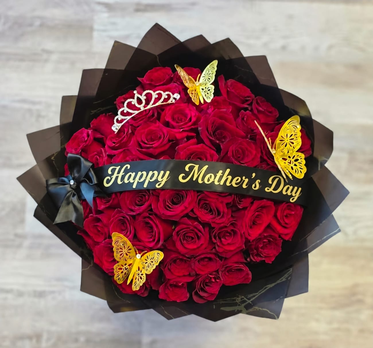 Rose Bouquet 3 - Our 25/50/75 Stem Rose Bouquet with custom banner, crown and butterflies delivers elegance, romance, and wow-factor in every bloom. Limited availability – order early!  If you would like to customize a rose bouquet please contact us today at 772-249-5688