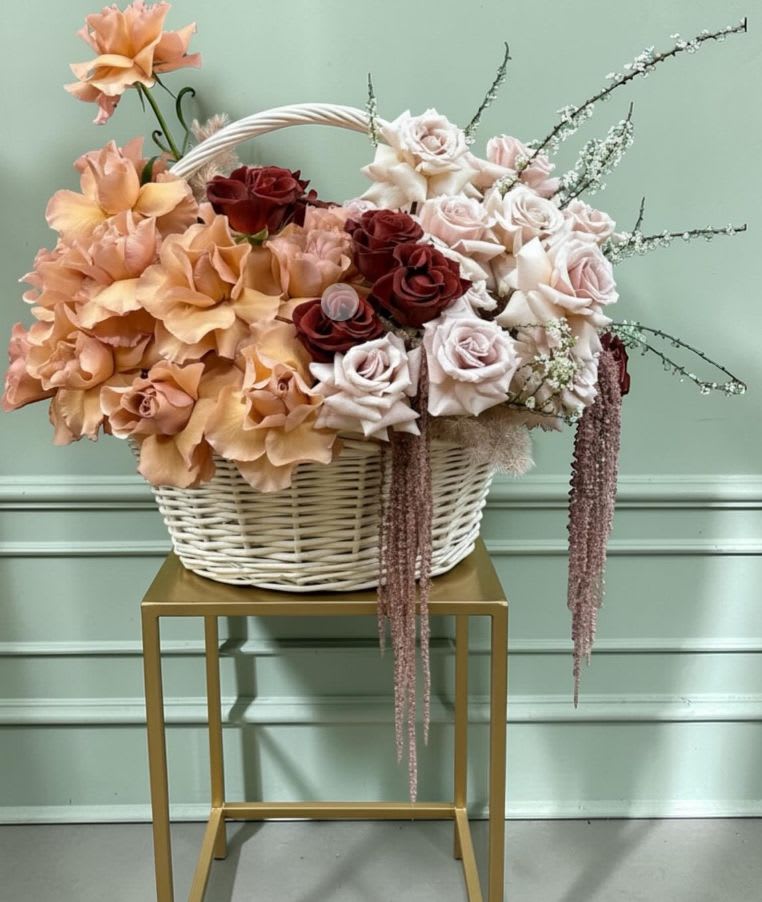 Basket of Roses - Where peach whispers meet blush and burgundy dreams , a basket full of quiet luxury.