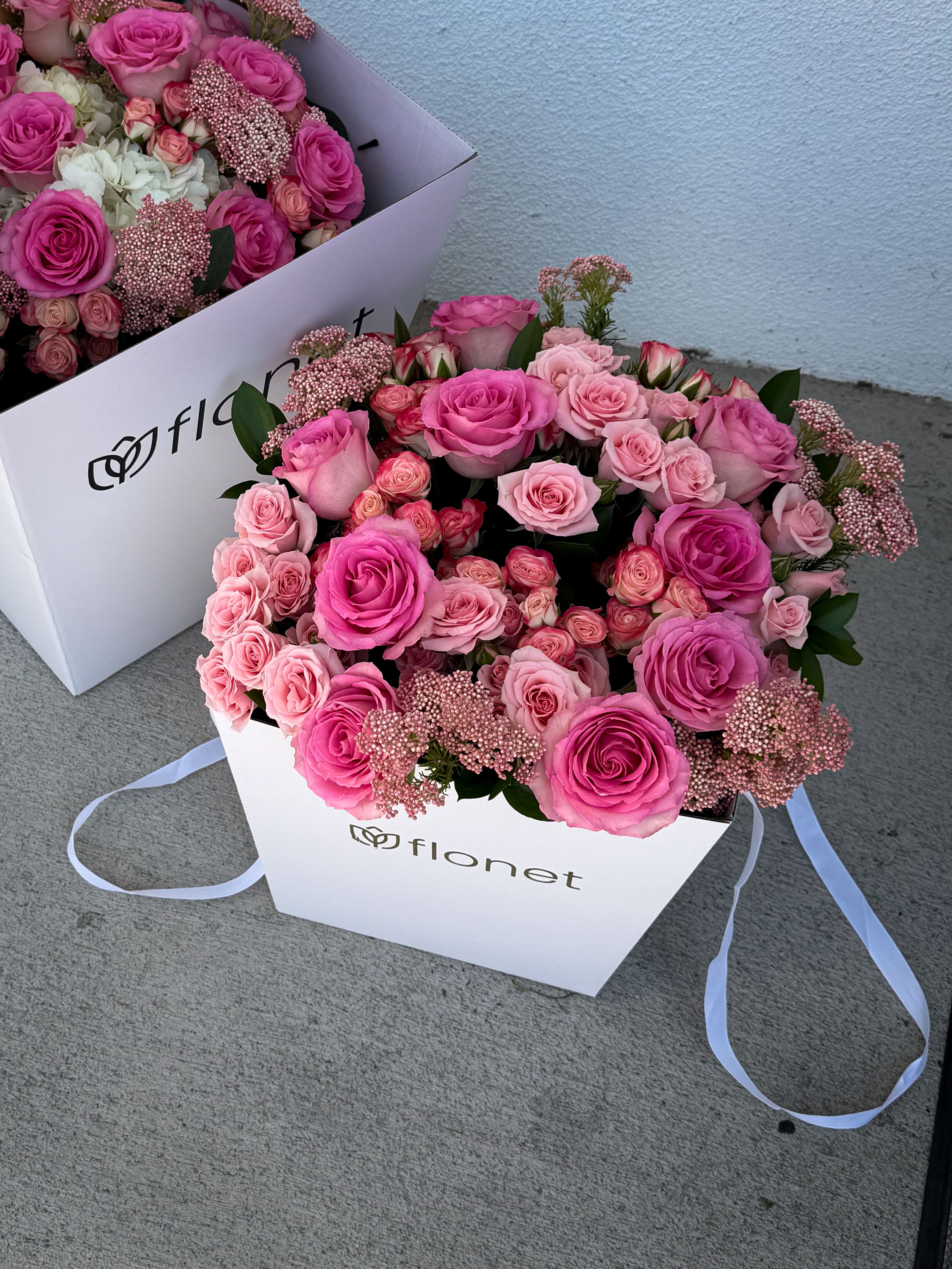 Pink Confidential - A luxurious floral box arrangement designed in layered shades of blush, ballet pink, and vibrant rose tones. Featuring premium roses, delicate spray roses, and soft textural accents, “Pink Confidential” feels romantic, polished, and effortlessly feminine. Arranged in Flonet’s signature keepsake box, this piece is designed to feel full from every angle — elegant enough for luxury gifting, yet soft enough to feel deeply personal. The mix of classic roses and miniature blooms creates richness, texture, and that unmistakable “opened from a movie scene” feeling. Perfect for birthdays, romantic gestures, thank-you gifts, or anyone obsessed with timeless pink florals.