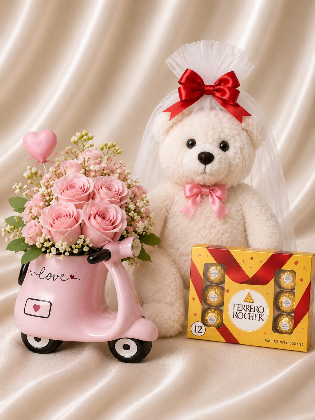 Pink rose bouquet in a scooter-shaped vase beside a teddy bear and chocolates