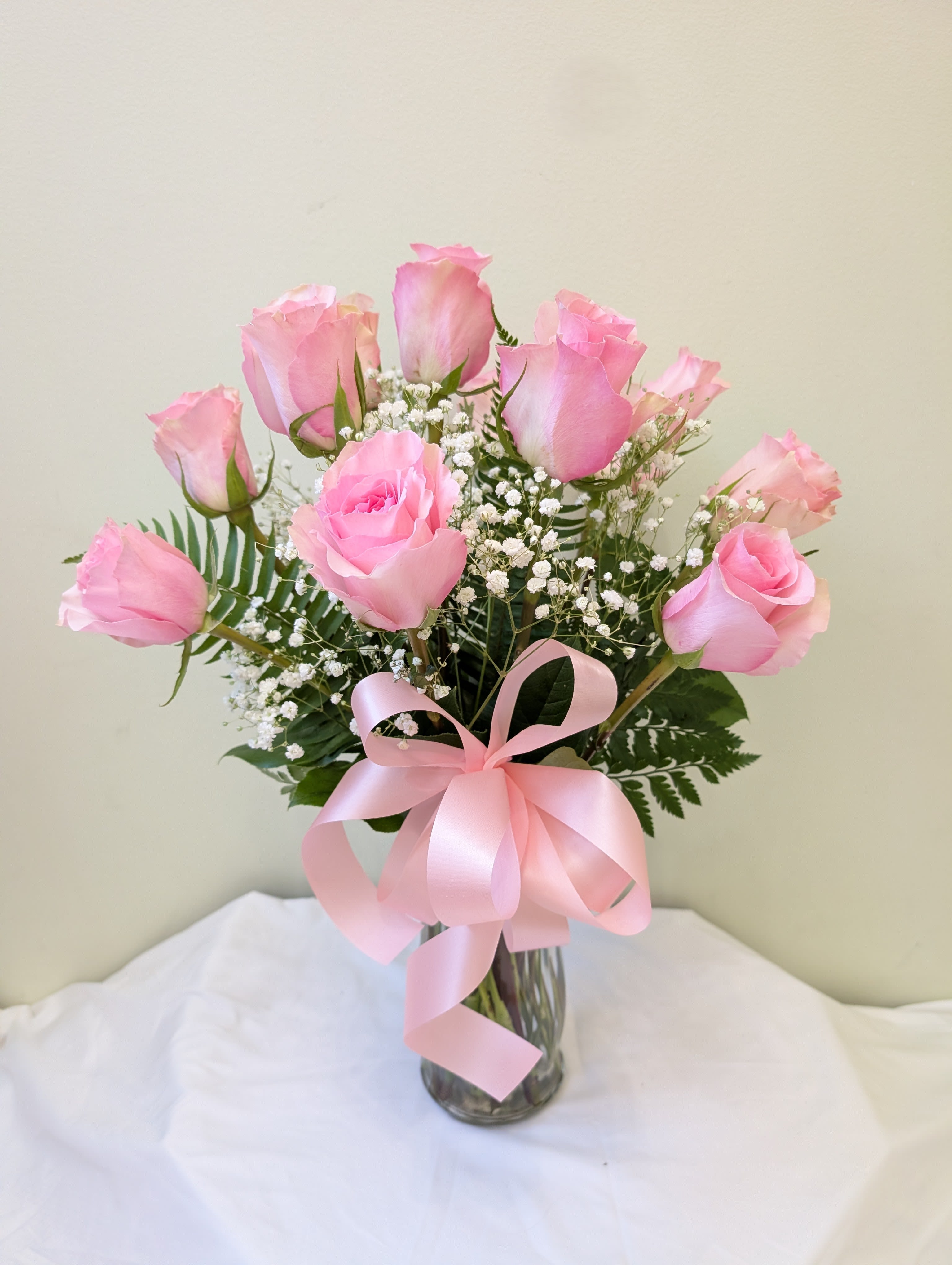 Dozen Long Stem Pink Roses with baby's breath - A dozen Pink roses are a classic gift! Perfect for Valentine's Day, an Anniversary, or any type of celebration.  Approximate Dimensions: 20"D x 30"H