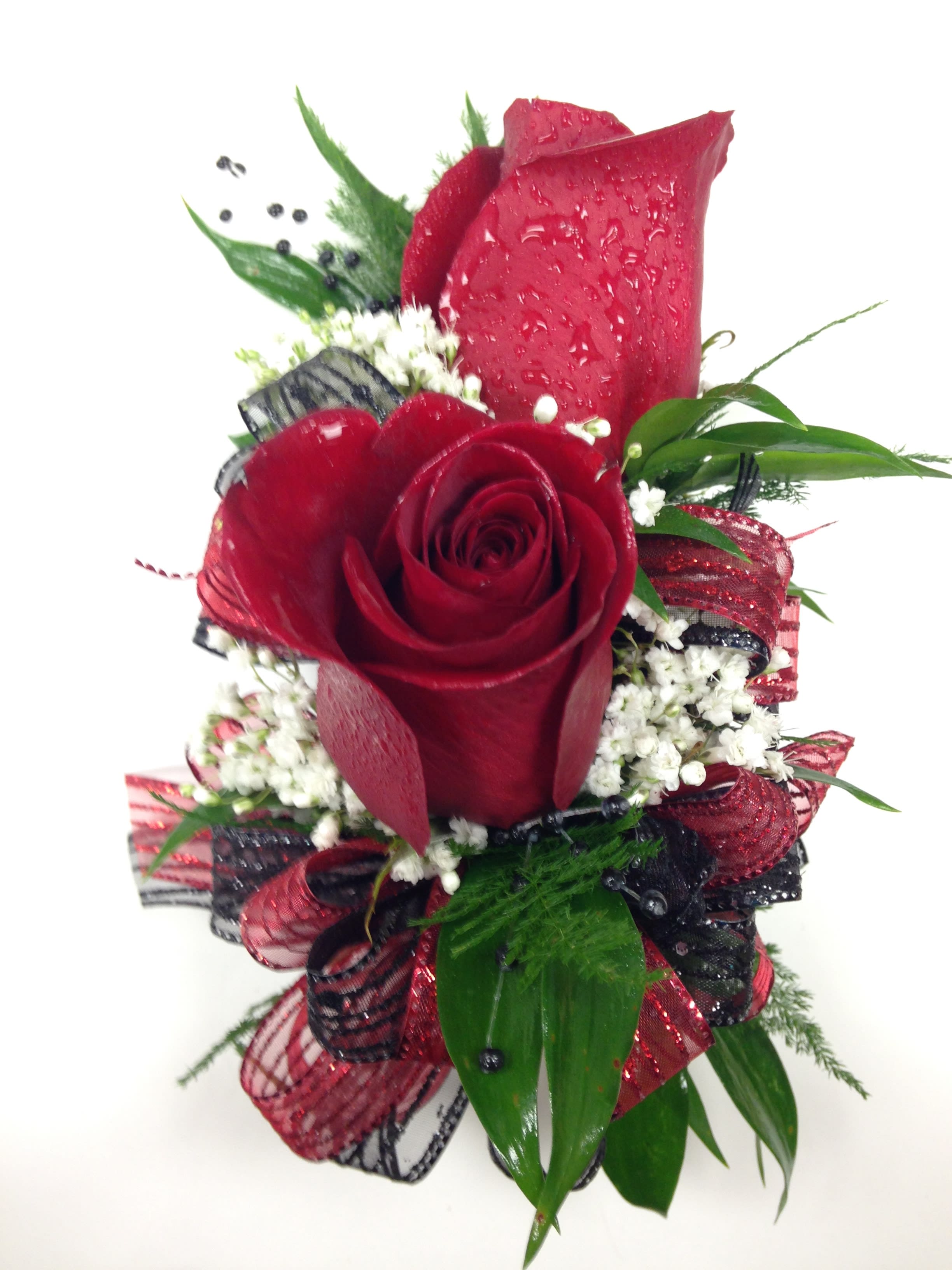Two Red Rose Corsage - Colors and ribbons may vary. When ordering please specify color of dress, color of roses preferred and color of ribbon preferred in order notes. Please include 2nd choice for ribbon colors. We will call you by phone if preferred ribbon color is unavailable.