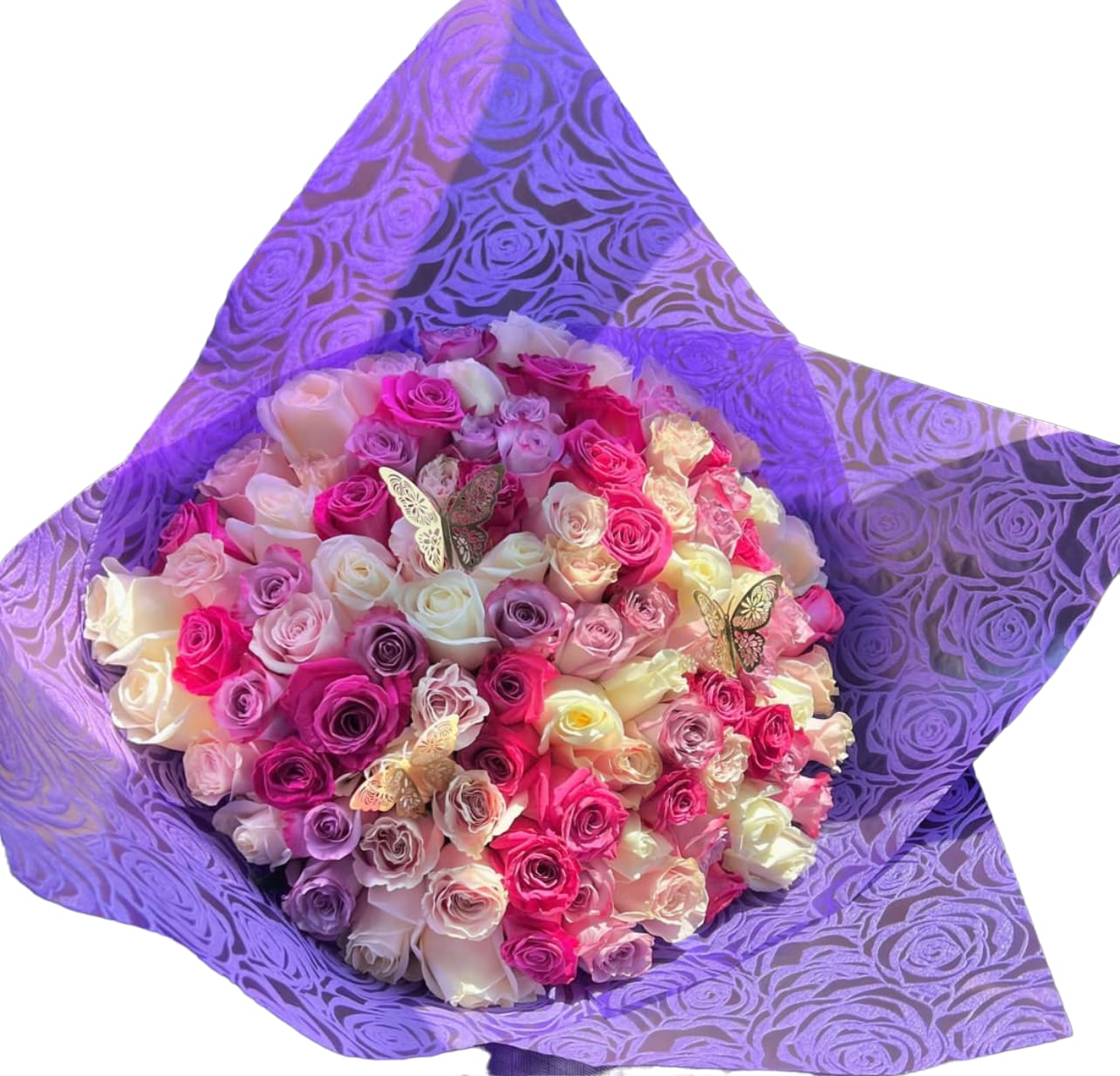 Bouquet of pink, white, and purple roses wrapped in purple paper