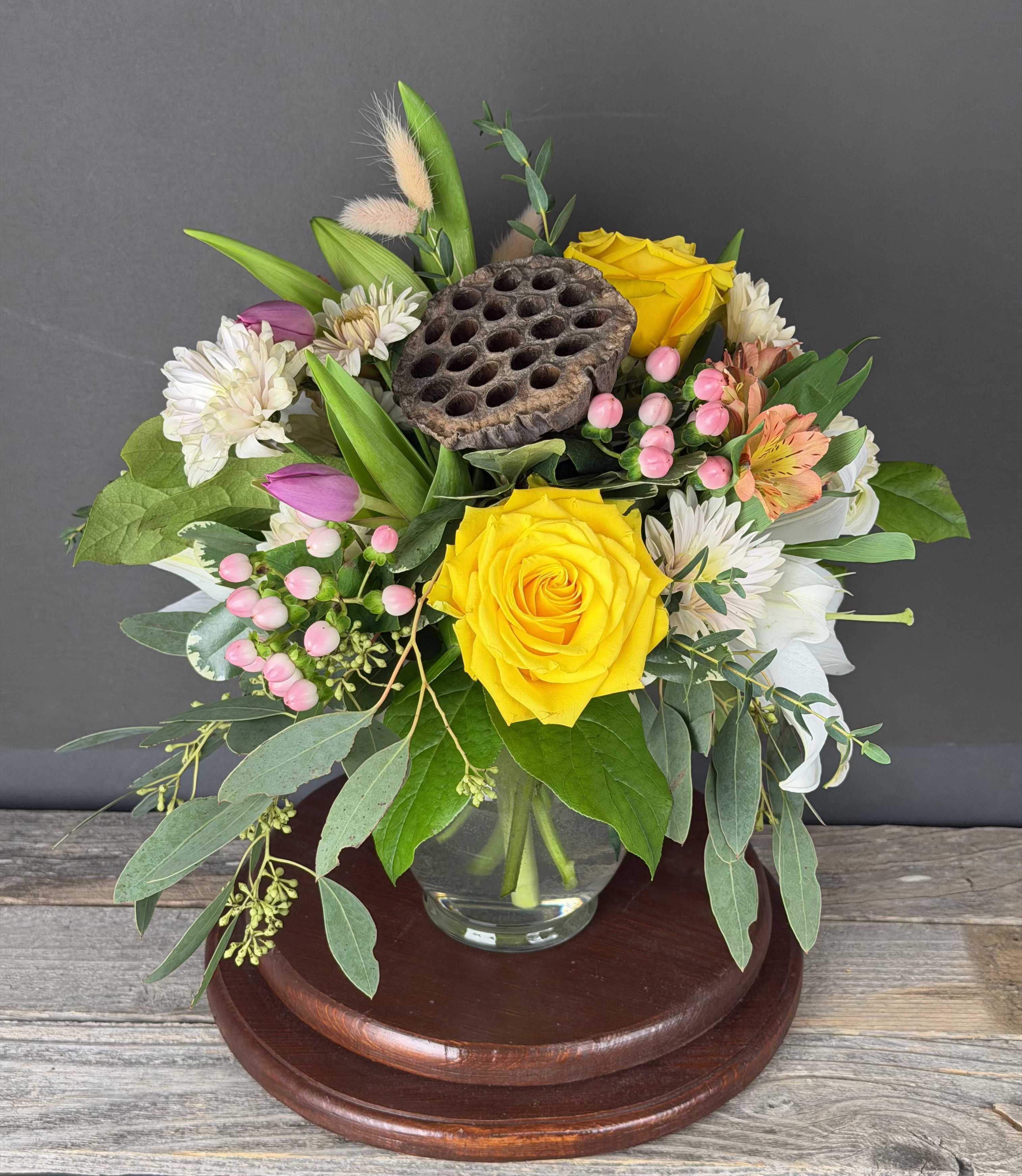 Sunny Day - This arrangement of roses, lilies and tulips is sure to bring sunshine to any space!