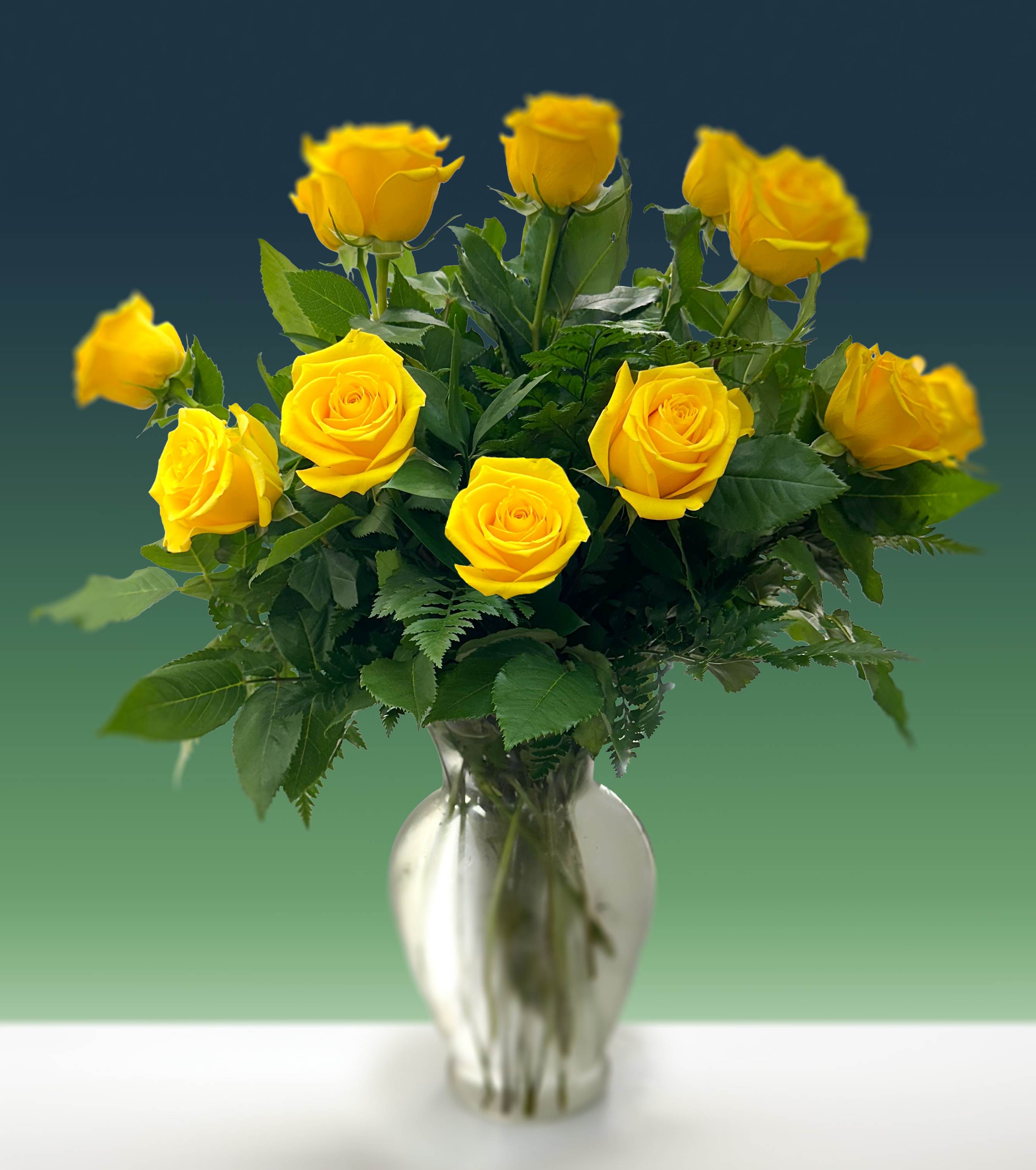Yellow roses arranged in a clear glass vase