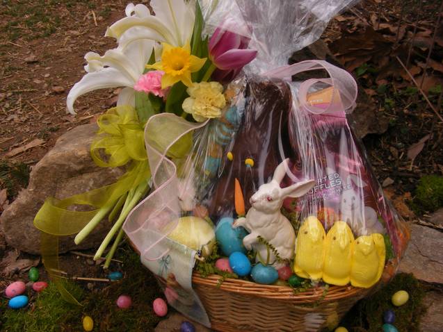 Basket of lilies and Easter candy with a rabbit figurine