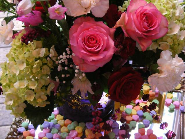 Pink and red roses with pale hydrangeas in a vase