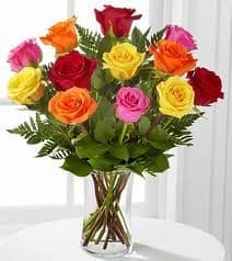 Bouquet of multicolored roses in a clear glass vase