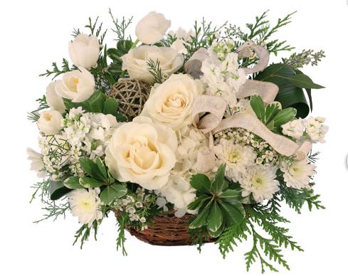 White roses and small white flowers in a wicker basket