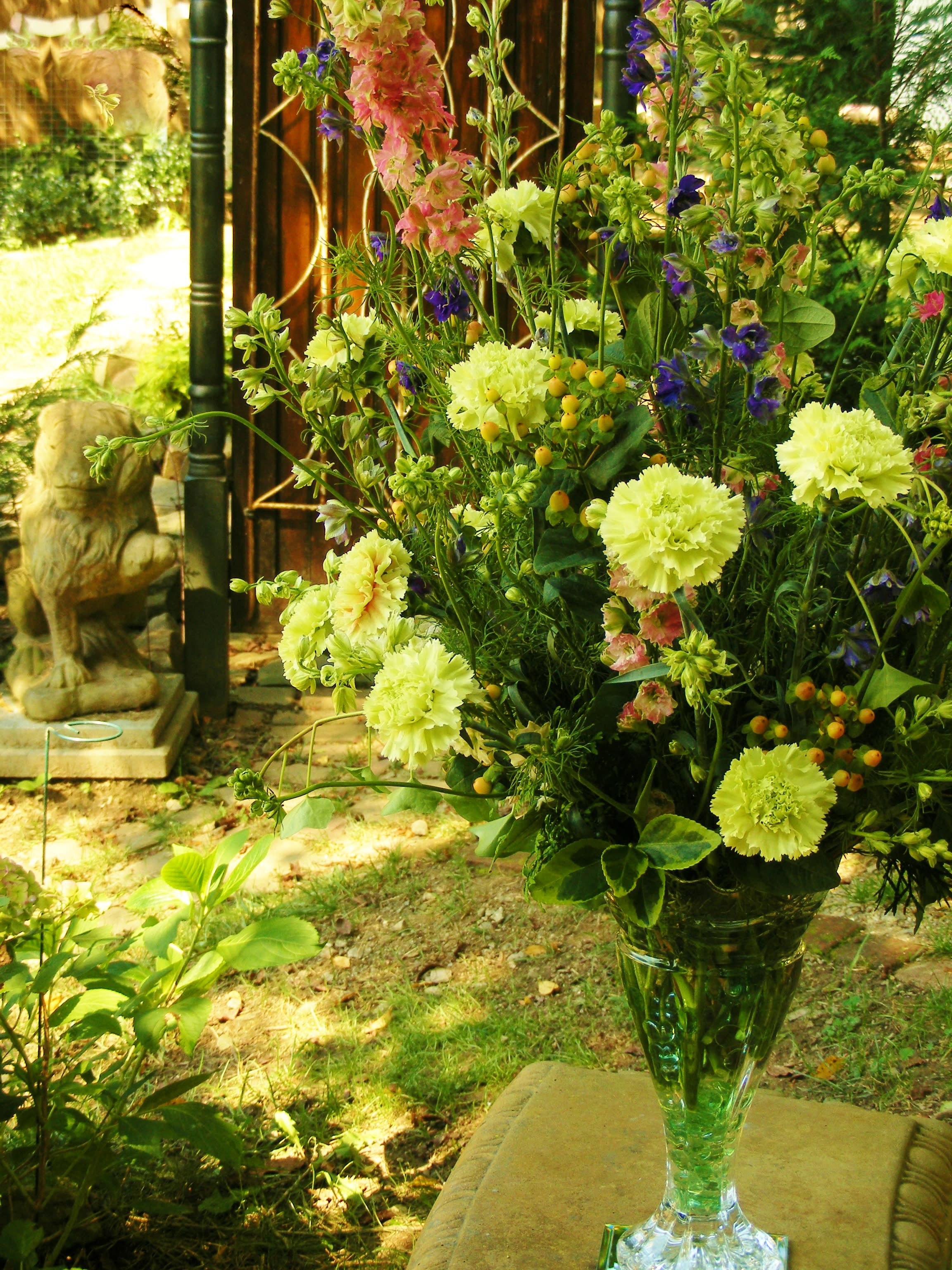 Tall mixed flower arrangement in a clear glass vase