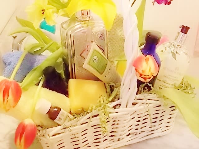 Gift basket with tulips, bath products, and soaps in a white wicker basket