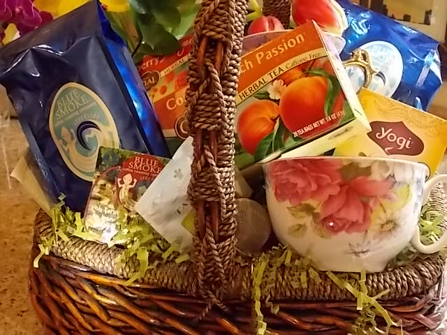 Gift basket with tea boxes and a floral teacup