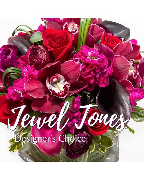 Bouquet of red roses and magenta orchids with dark foliage