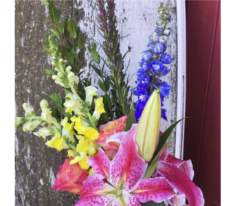 Bouquet with pink lilies, yellow snapdragons, and blue delphinium