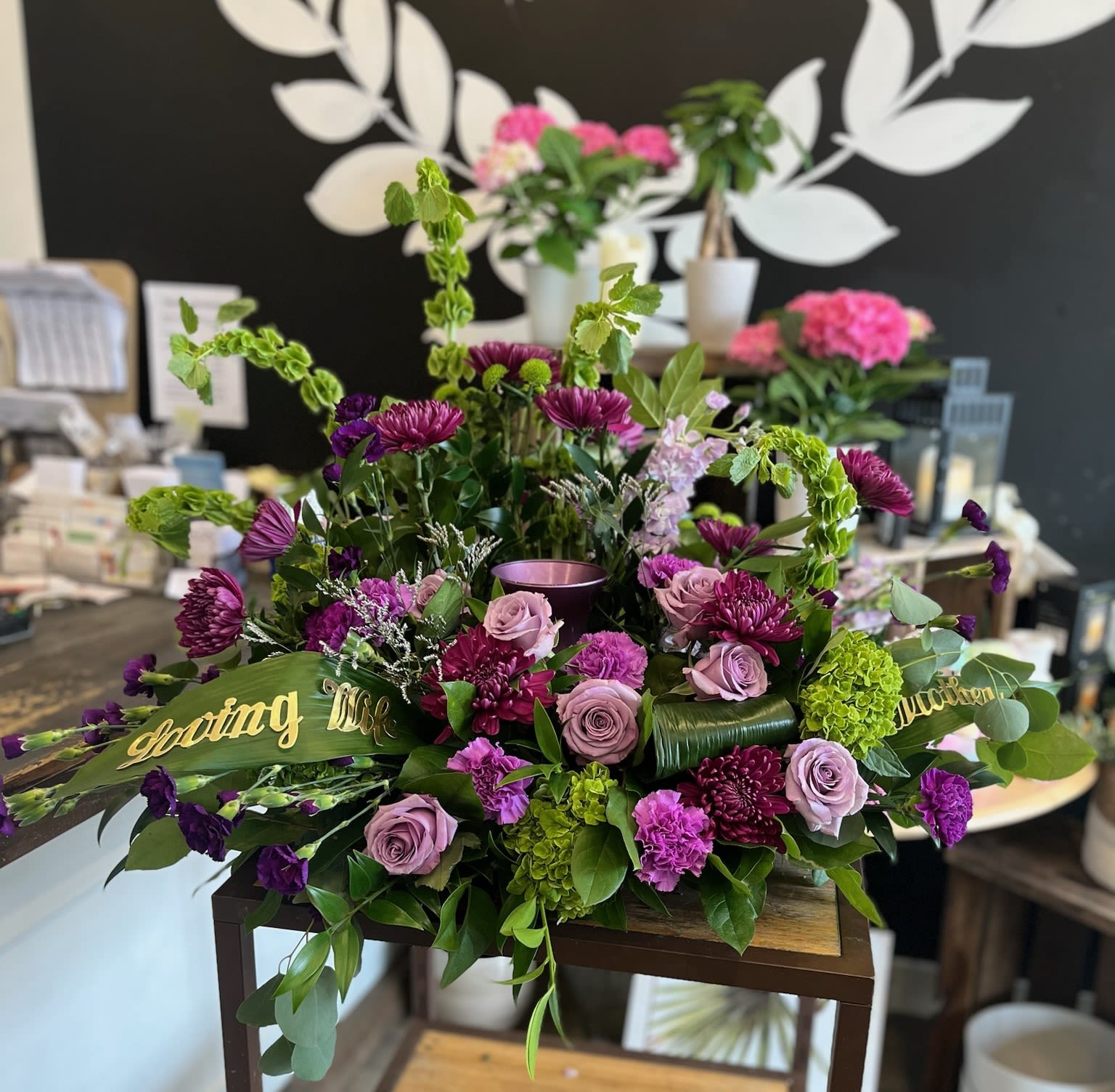 Purple and pink floral arrangement with roses and chrysanthemums