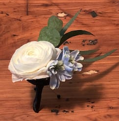 White boutonniere with a pale blue accent flower