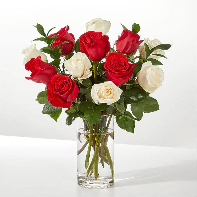 Santa Baby Rose Flower  -  Pet Friendly? Yes. Roses are generally considered non-toxic to cats and dogs.  Thorns can still pose a risk—keep out of reach of curious household pets.   Human Allergy Note : No major allergy-triggering flowers noted.   Care &amp; Longevity : Keep the arrangement in a cool room away from direct sun, heat, or vents. Add fresh water as needed and remove fading blooms promptly to extend freshness.   Best Occasions &amp; Situations : - Christmas flower gift - Winter anniversary - Holiday dinner centerpiece - Boss’s Day appreciation - Festive housewarming - New Year celebration - December birthday   Why Customers Love It : - Long-lasting premium roses. - Fragrant winter greenery fills the room with a holiday scent. - Classic color balance that fits any decor. - Sturdy, gift-ready glass vase. - Versatile design for both home and office.