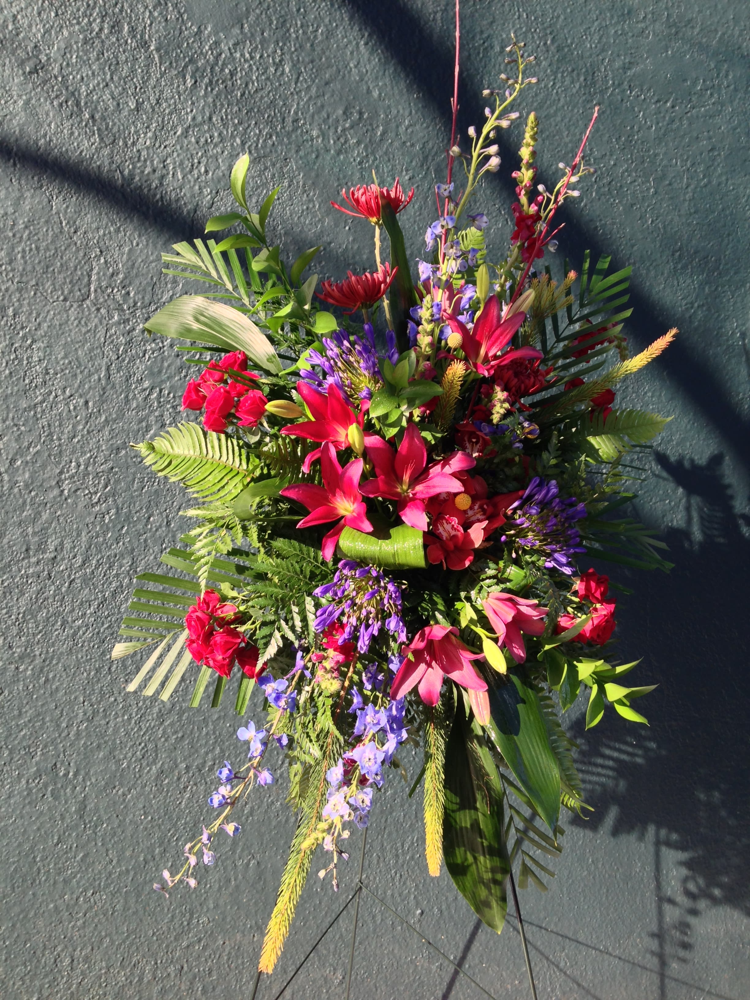Bright tropical floral spray with pink lilies and purple accents